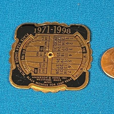 VINTAGE METAL POCKET DIAL-A-DATE PERPETUAL CALENDAR 