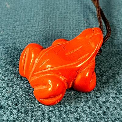 CARVED REDDISH-ORANGE STONE FROG FETISH NECKLACE ON BLACK CORD