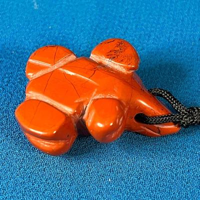 CARVED REDDISH-ORANGE STONE FROG FETISH NECKLACE ON BLACK CORD