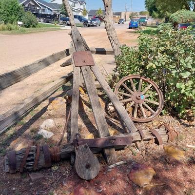ANTIQUE WAGON AXLE, WHEEL AND A WOODEN PULLEY