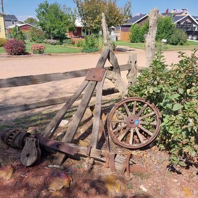 ANTIQUE WAGON AXLE, WHEEL AND A WOODEN PULLEY