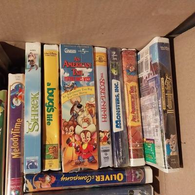 BOX FULL OF MOSTLY WALT DISNEY MOVIES IN CLAM SHELL CASES