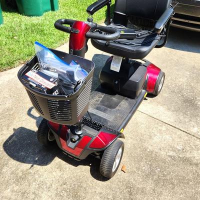 Lot #247  PRIDE GO GO scooter - like new - also has motorized car carrier