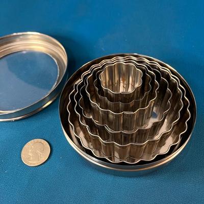 SET OF 6 NESTING FLOWER SHAPED COOKIE CUTTERS IN METAL STORAGE TIN
