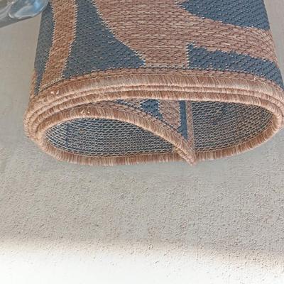 OUTDOOR AREA RUG WITH FOLDING SHOVELS AND CHEMICAL SPRAYER
