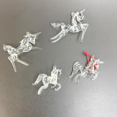 Lot 318. Lot of Four Clear Glass Unicorn Ornaments