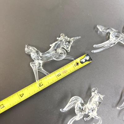 Lot 318. Lot of Four Clear Glass Unicorn Ornaments