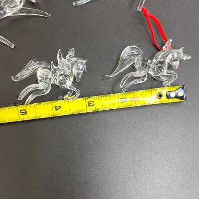 Lot 318. Lot of Four Clear Glass Unicorn Ornaments