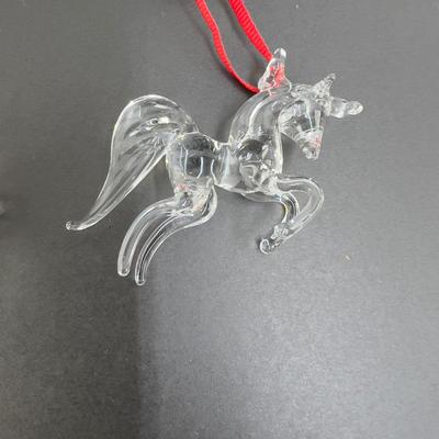 Lot 318. Lot of Four Clear Glass Unicorn Ornaments