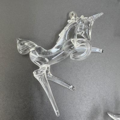 Lot 318. Lot of Four Clear Glass Unicorn Ornaments