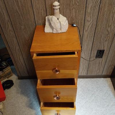 WOODEN  THREE DRAWER CABINET AND STONE LIGHTHOUSE LIGHT