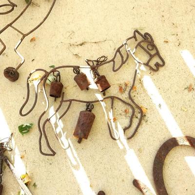 RUSTIC BELLS HUNG FROM VARIETY OF SHAPES AND HORSESHOES