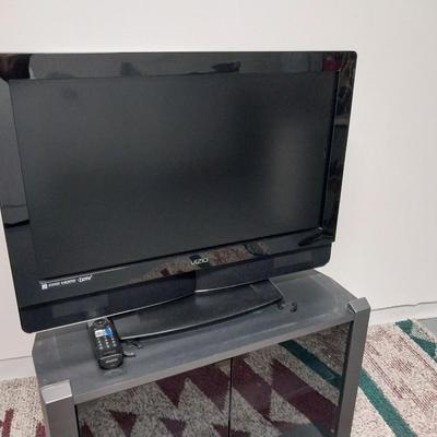 32"XIZIO WITH REMOTE AND GLASS FRONT STAND WITH STORAGE