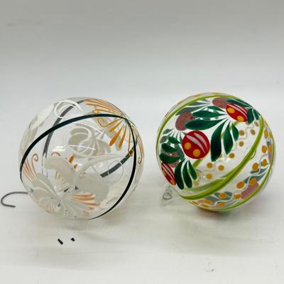 Pair of Clear Blown Glass Christmas Holiday Ball Ornaments with Festive Hand Painted Designs