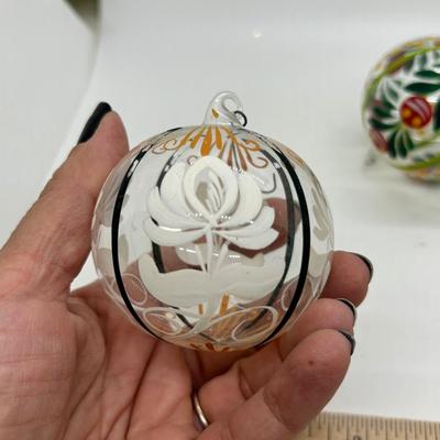 Pair of Clear Blown Glass Christmas Holiday Ball Ornaments with Festive Hand Painted Designs