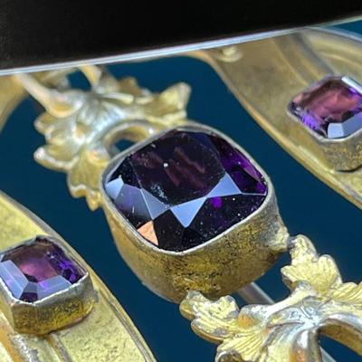 GOLD TONE VICTORIAN BROOCH WITH PURPLE FACETED GLASS STONES