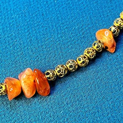 INTERESTING ORANGE STONE AND LACEY GOLD TONE BEAD NECKLACE