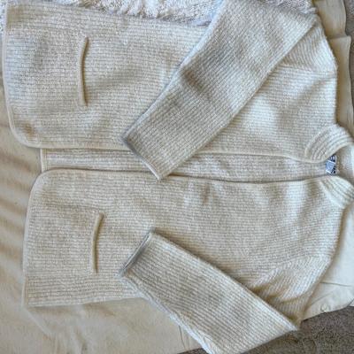 Two white sweaters