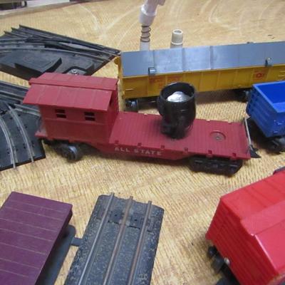 Collection of Model Railroad Cars, Tracks, and Accessories