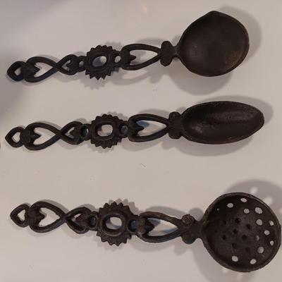 Cast Iron candle sconces with three vintage Cast Iron Triple Heart Kitchen utensils.