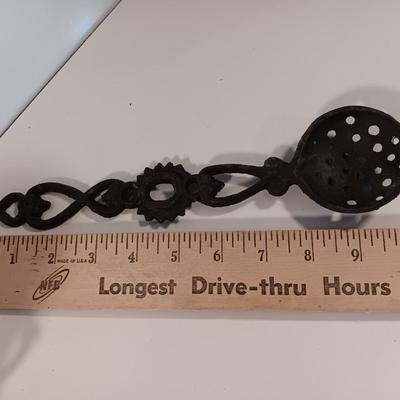 Cast Iron candle sconces with three vintage Cast Iron Triple Heart Kitchen utensils.