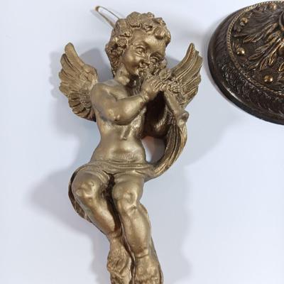 TWO cherub Decorative Antiques. One chalkware wall art and one brass colored decorative piece