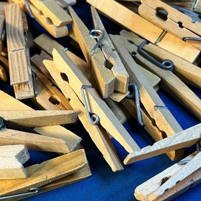 PILE OF MOSTLY WOODEN CLOTHES PINS