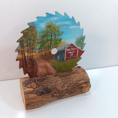 Hand painted saw blade signed by artist Chew Mail Pouch Tobacco barn with log display