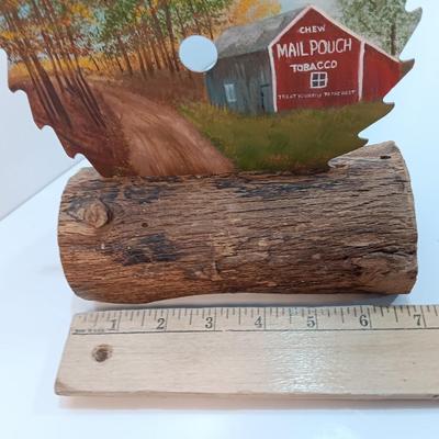 Hand painted saw blade signed by artist Chew Mail Pouch Tobacco barn with log display
