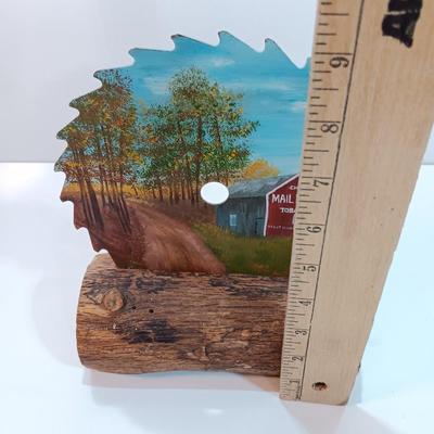 Hand painted saw blade signed by artist Chew Mail Pouch Tobacco barn with log display