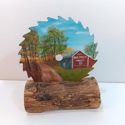 Hand painted saw blade signed by artist Chew Mail Pouch Tobacco barn with log display