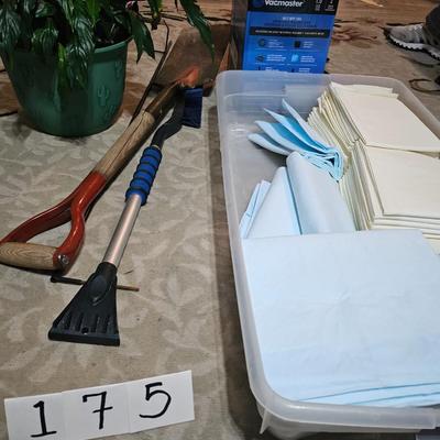 Assortment of goods including: pads, mini detail vacum, shovel, beautiful peace lilies