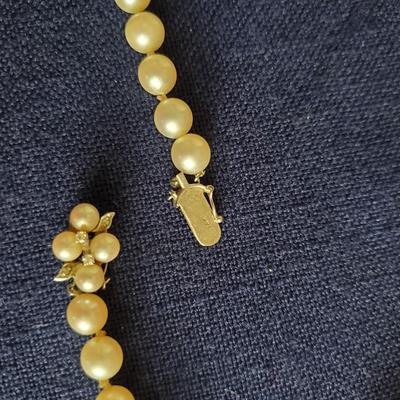 14K Diamond and sapphire clasp on high luster ivory colored pearl necklace.