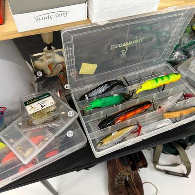 Lot 19: Fishing reels, hundreds of dollars in fishing Lures, Hunting attire & more