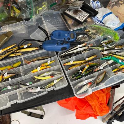 Lot 19: Fishing reels, hundreds of dollars in fishing Lures, Hunting attire & more