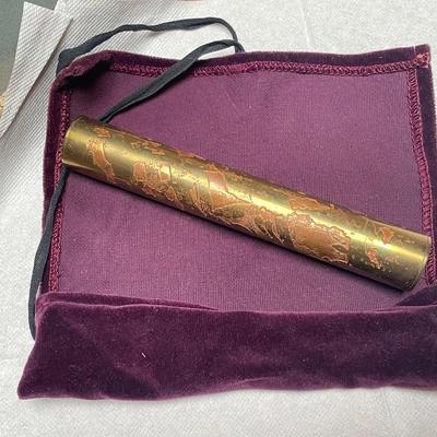 Metal kaleidoscope in velvet case.