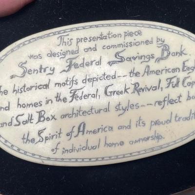 Composite box with eagle, house, and script.