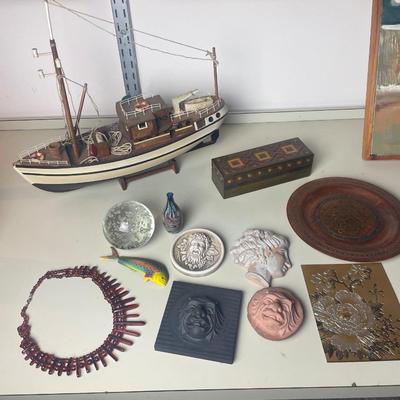 Lot of assorted Faces, paperweights, plate, boat, box.