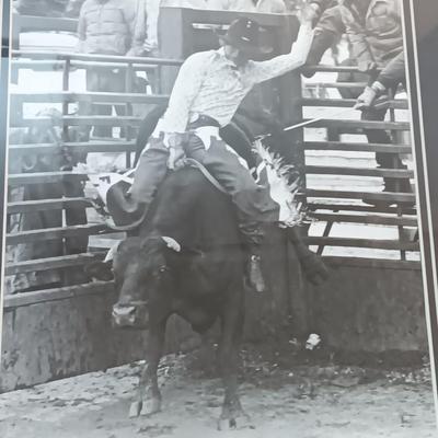 Barn wood framed black and white Bull Rider artwork.