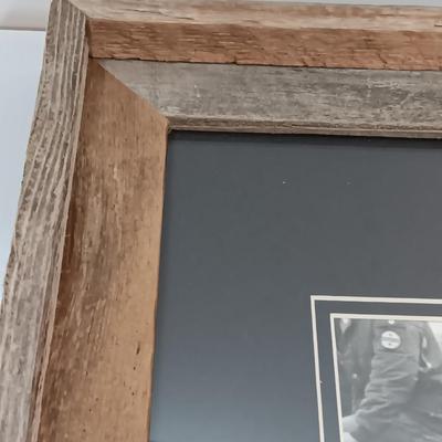Barn wood framed black and white Bull Rider artwork.