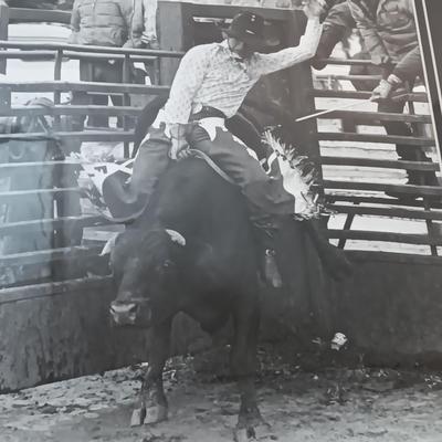 Barn wood framed black and white Bull Rider artwork.