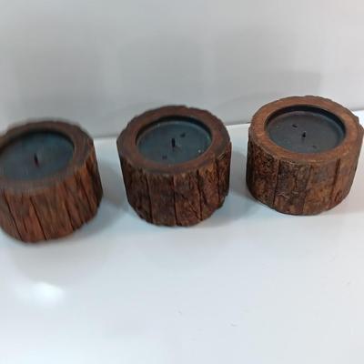 Three rustic wooden pillar candle holders