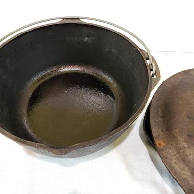 Lot #132  Two Cast Iron pieces - Dutch over with lid and Griddle
