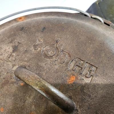 Lot #132  Two Cast Iron pieces - Dutch over with lid and Griddle