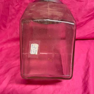 Tilted apothecary glass jar