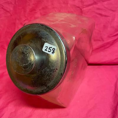 Tilted apothecary glass jar