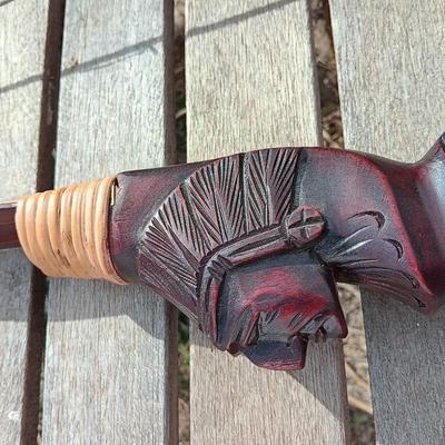 Hand carved two faced Native American head archery decorative bow with arrows.