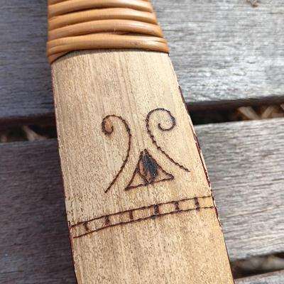 Hand carved two faced Native American head archery decorative bow with arrows.