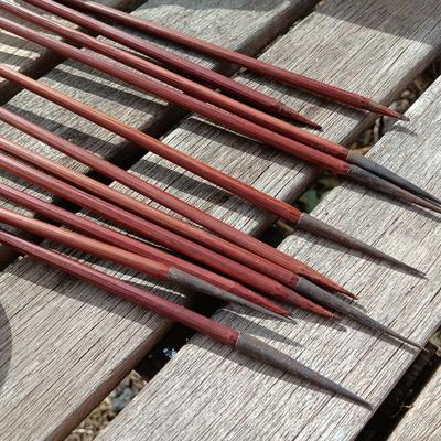 Hand carved two faced Native American head archery decorative bow with arrows.
