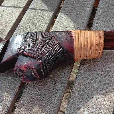 Hand carved two faced Native American head archery decorative bow with arrows.